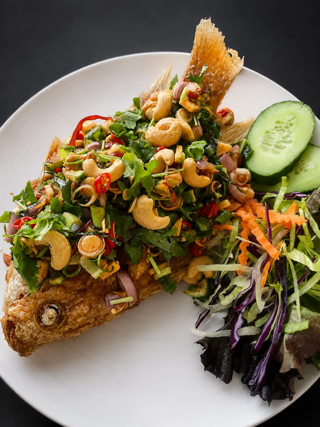 Crispy fried fish with herb and cashew salad at Tawan Chay