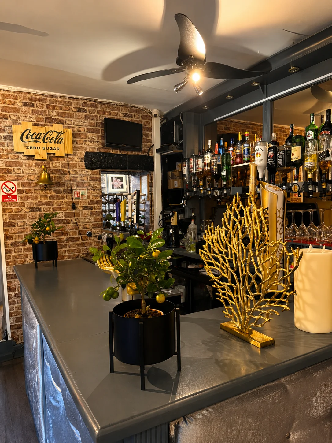 Bar area at Tawan Chay with exposed brick wall and Thai decor